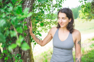 Alix standing next to a tree